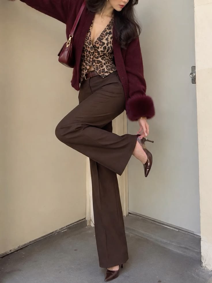 Burgundy cardigan styled with leopard print top and brown trousers Burgundy cardigan styled with leopard print top and brown trousers